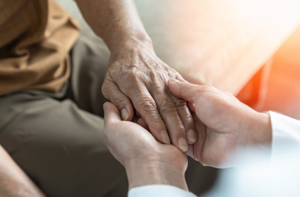 A family member is holding their loved one's hand.