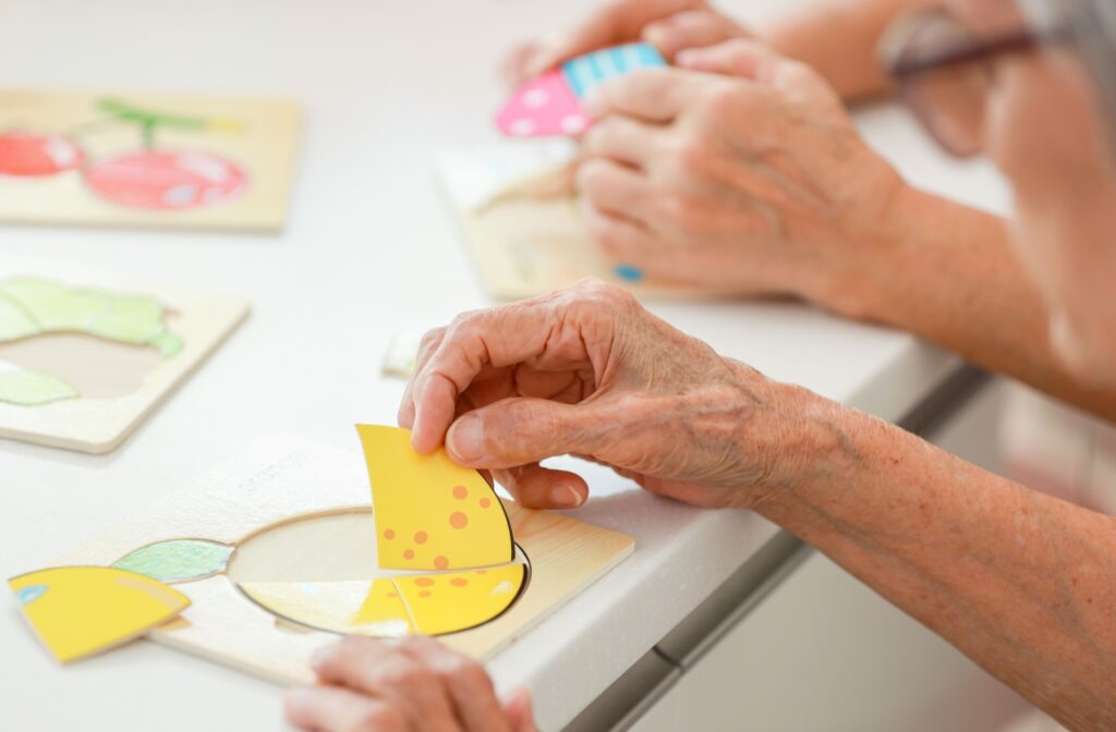 A senior with Alzheimer's engaging in a cognitive building activity to stimulate memory and maintain motor skills. 