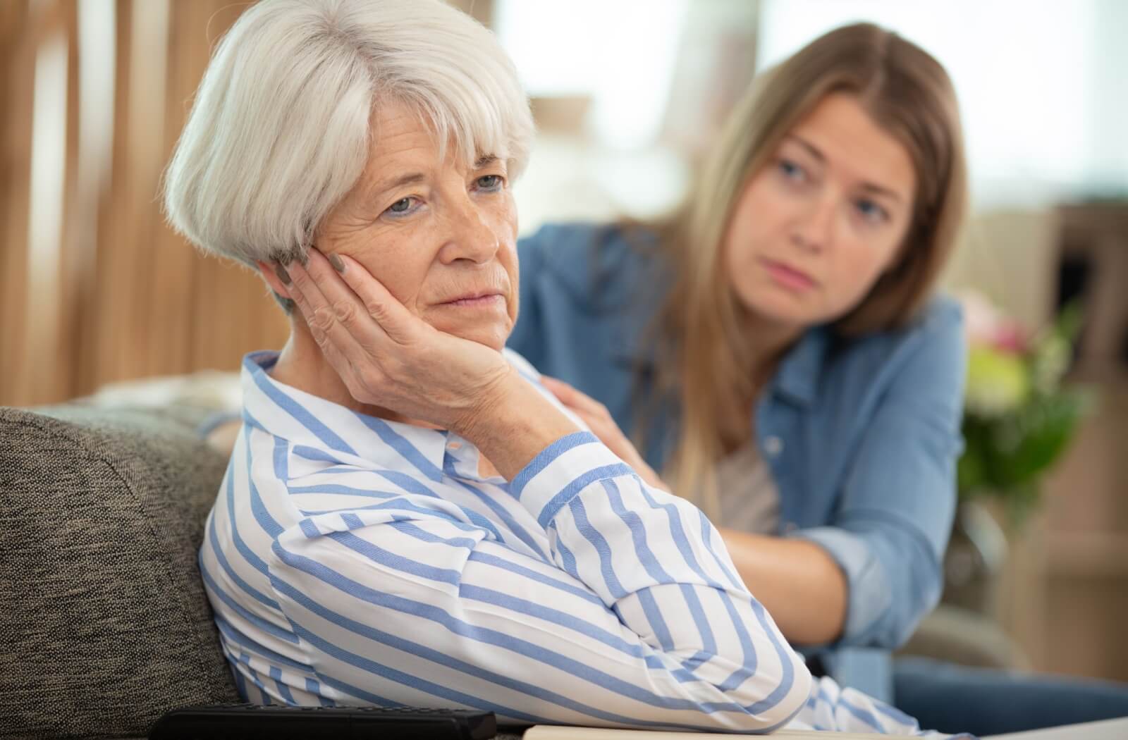 An adult child and their senior parent suffering from dementia struggling to communicate
